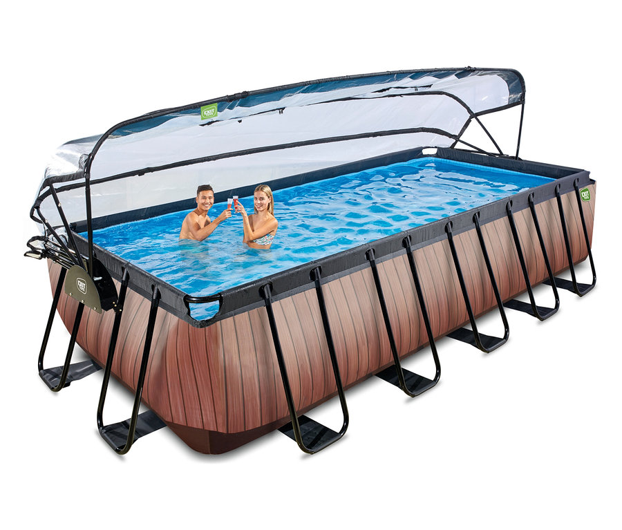 Ein Mann und eine Frau stoßen in einem EXIT Pool-Set in Holzoptik (540 x 250 cm) mit transparentem Verdeck an.