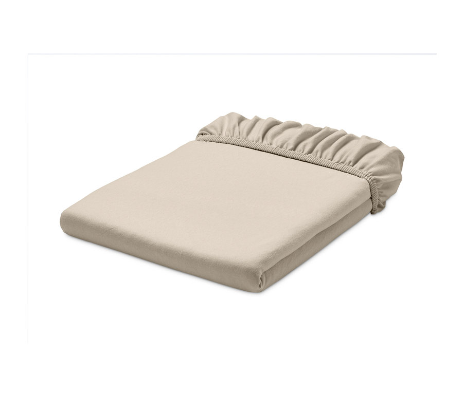 Ein gefaltetes Jersey-Spannbettlaken in Creme.