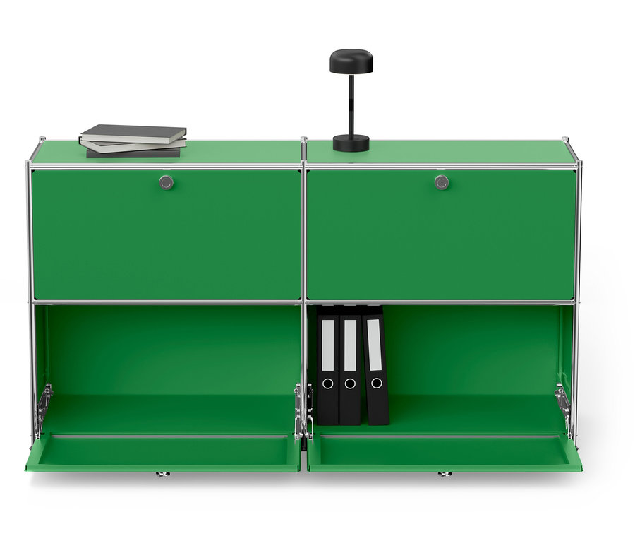 Grüner modularer Schrank mit silbernem Rahmen, oben eine Lampe und Bücher, unten drei schwarze Ordner.