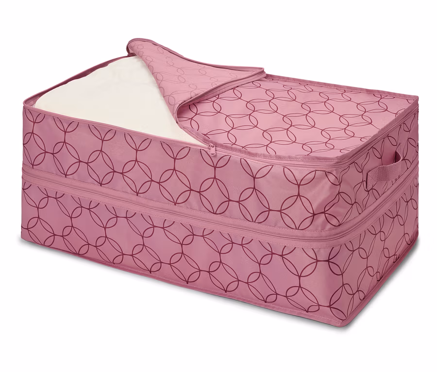 Rosa Aufbewahrungstasche mit Reißverschluss und Kreismuster, teilweise geöffnet, mit weißem Kissen darin.