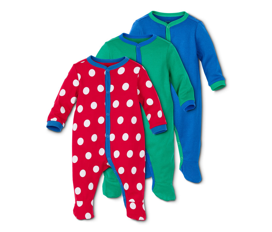 Drei Schlafanzüge: rot mit weißen Punkten, grün und blau.