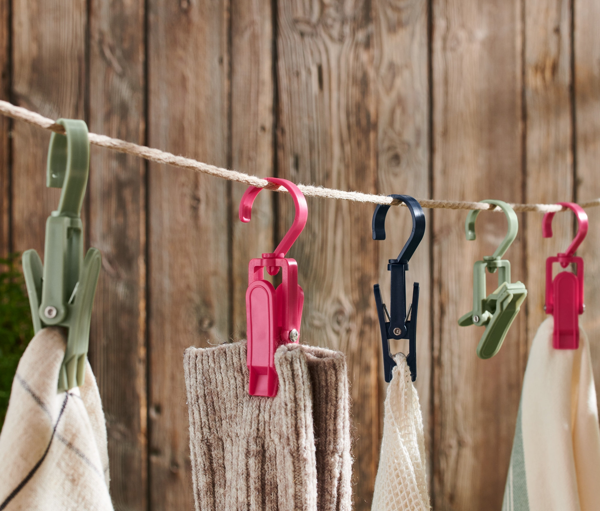 Verschiedenfarbige 6 Outdoor-Clips hängen an einer Schnur und halten Stoff.