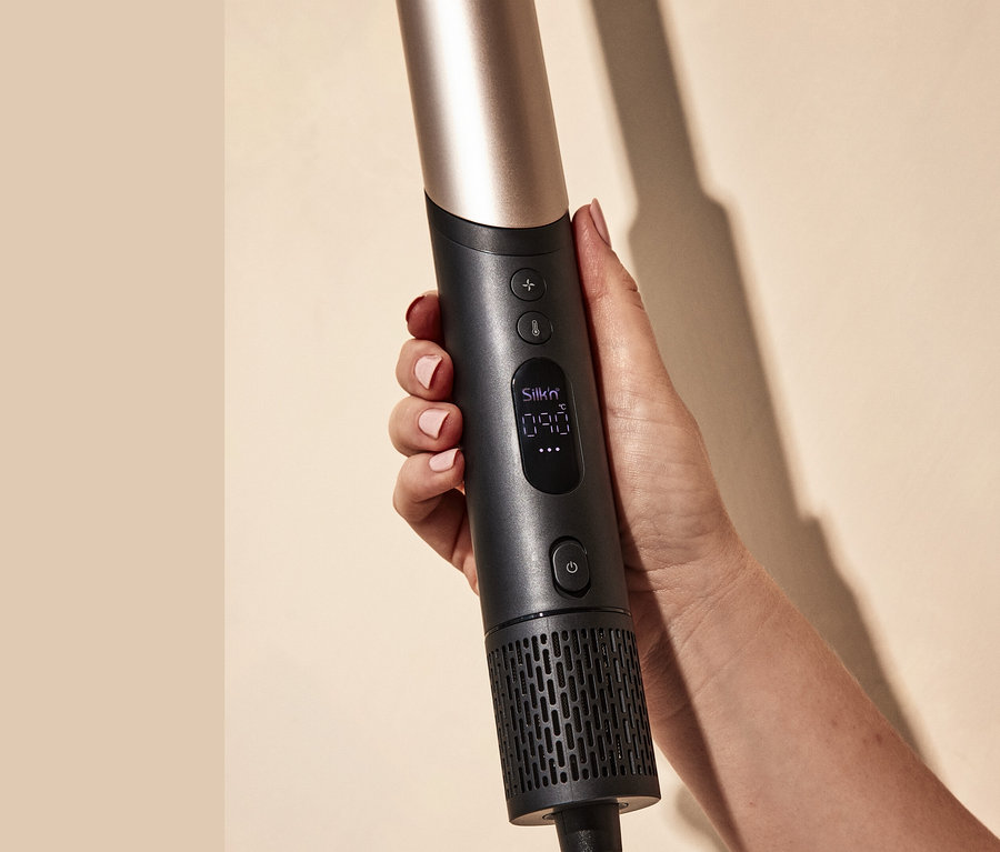 Eine Frau hält einen Silk'n Multihaarstyler »SilkyAirFlex« in der Hand.