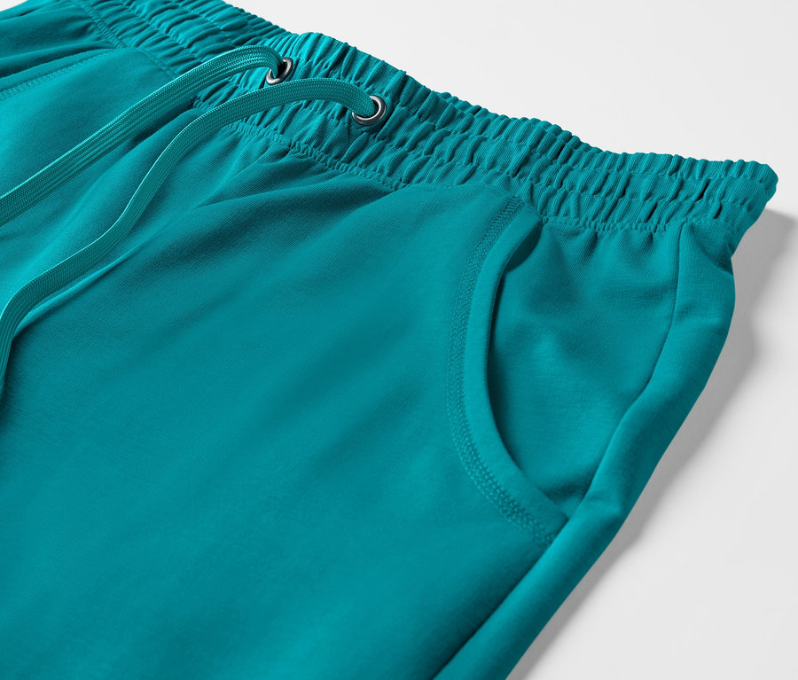 Detail einer türkis 3/4-Sweathose mit elastischem Bund und Kordelzug.