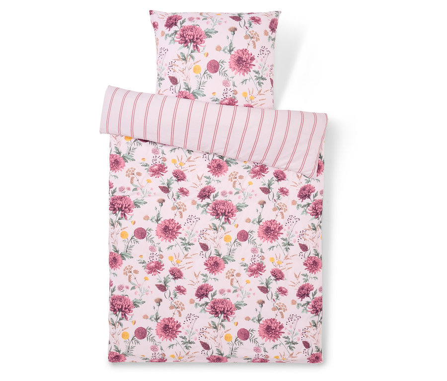 Bettwäsche mit Blumenmuster und gestreiftem Kissen.