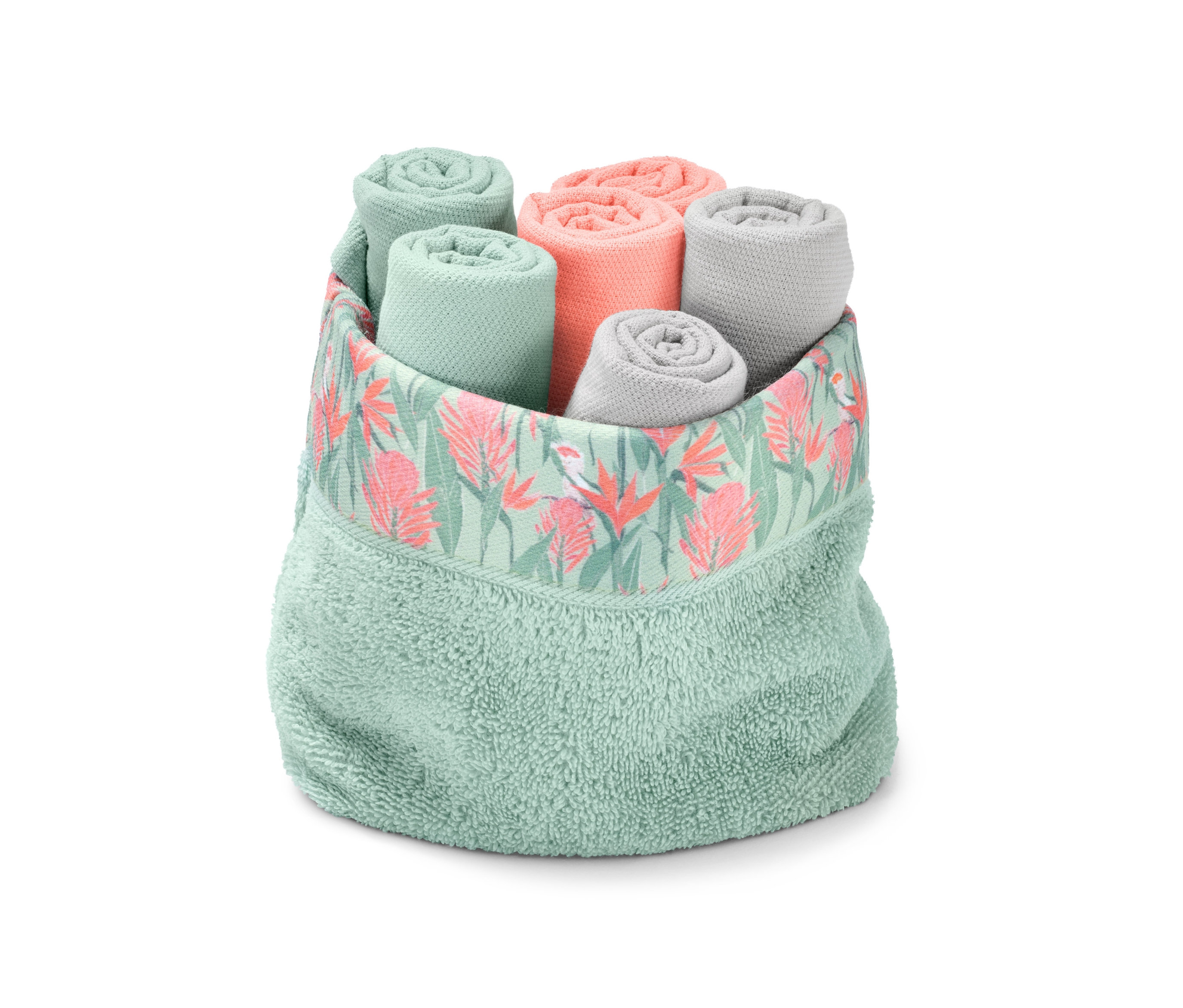 Sechs zusammengerollte Gästehandtücher in einem dekorativen grünen Halter.