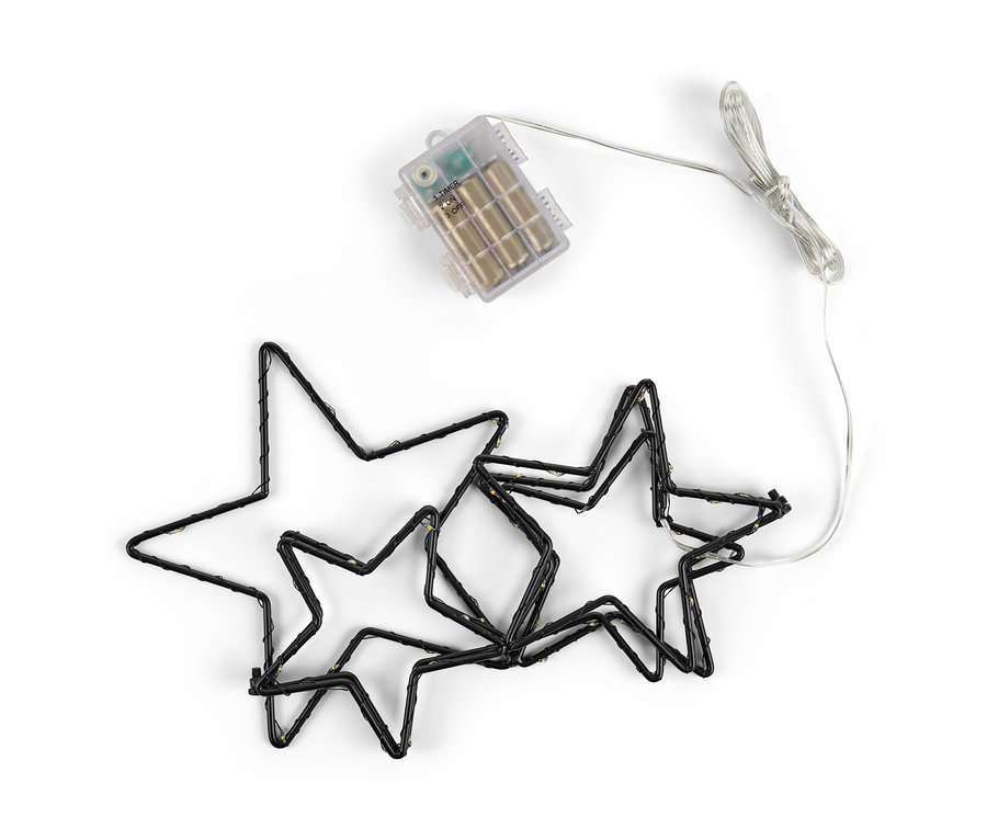 Schwarze LED-Outdoor-Sternensilhouette und LED-Sternschnuppe auf weißem Hintergrund.