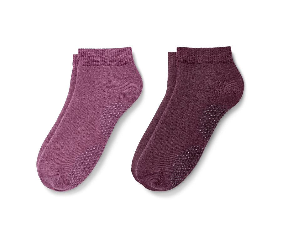 Zwei Paar Yogasocken in Rosé und Mauve.