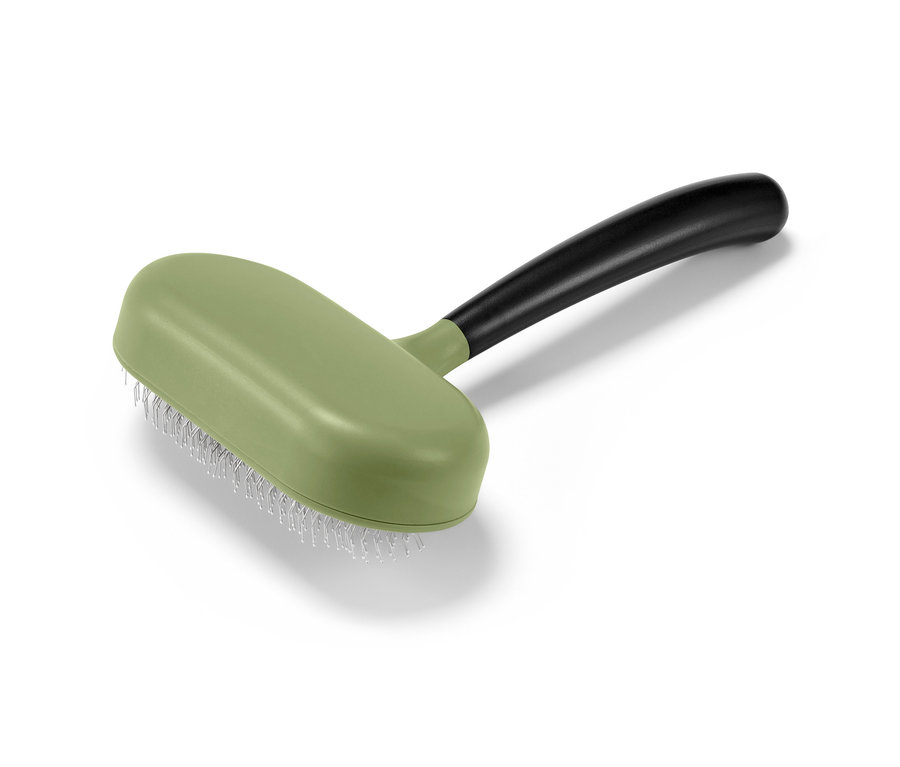 Eine grüne Tier-Fellbürste mit einem schwarzen Griff.