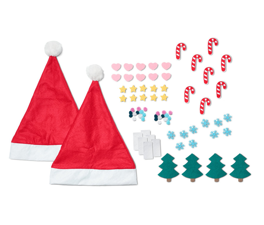 Zwei rote Mützen neben einem Set Weihnachtsdekorationen.