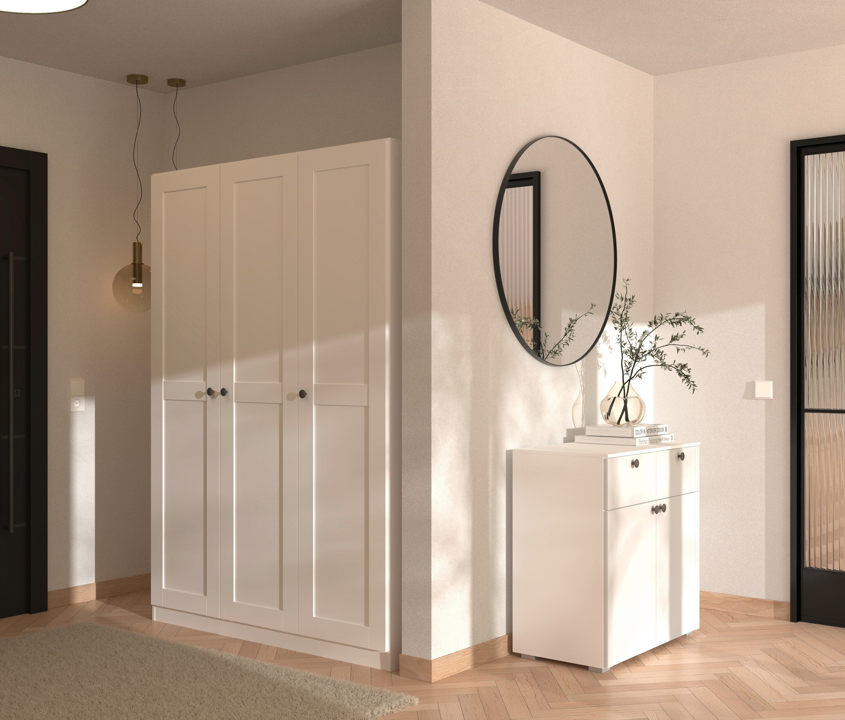 Eingangsbereich mit weißem dreitürigem Kleiderschrank, weißem Schuhschrank, rundem Spiegel und dekorativer Vase.