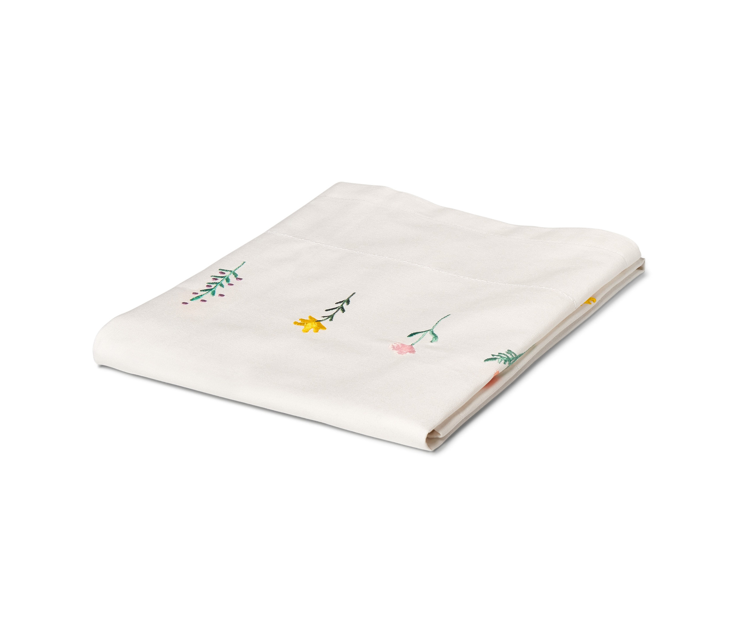 Gefaltete, weiße Mitteldecke mit Blumenmuster.