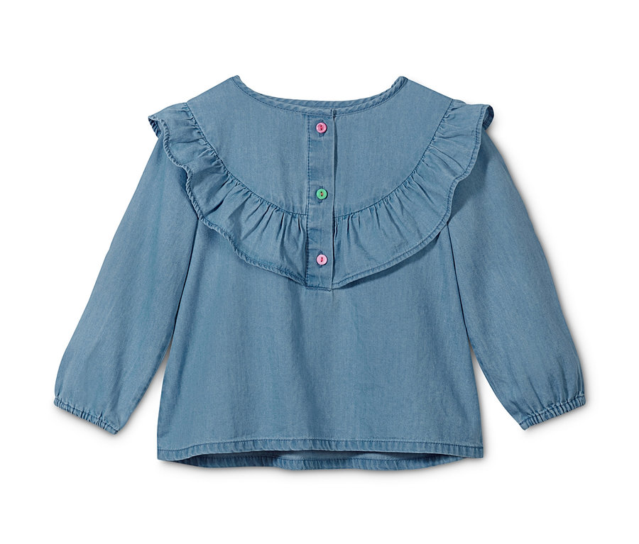 Eine blaue Chambray-Bluse mit langen Ärmeln und Rüschen.