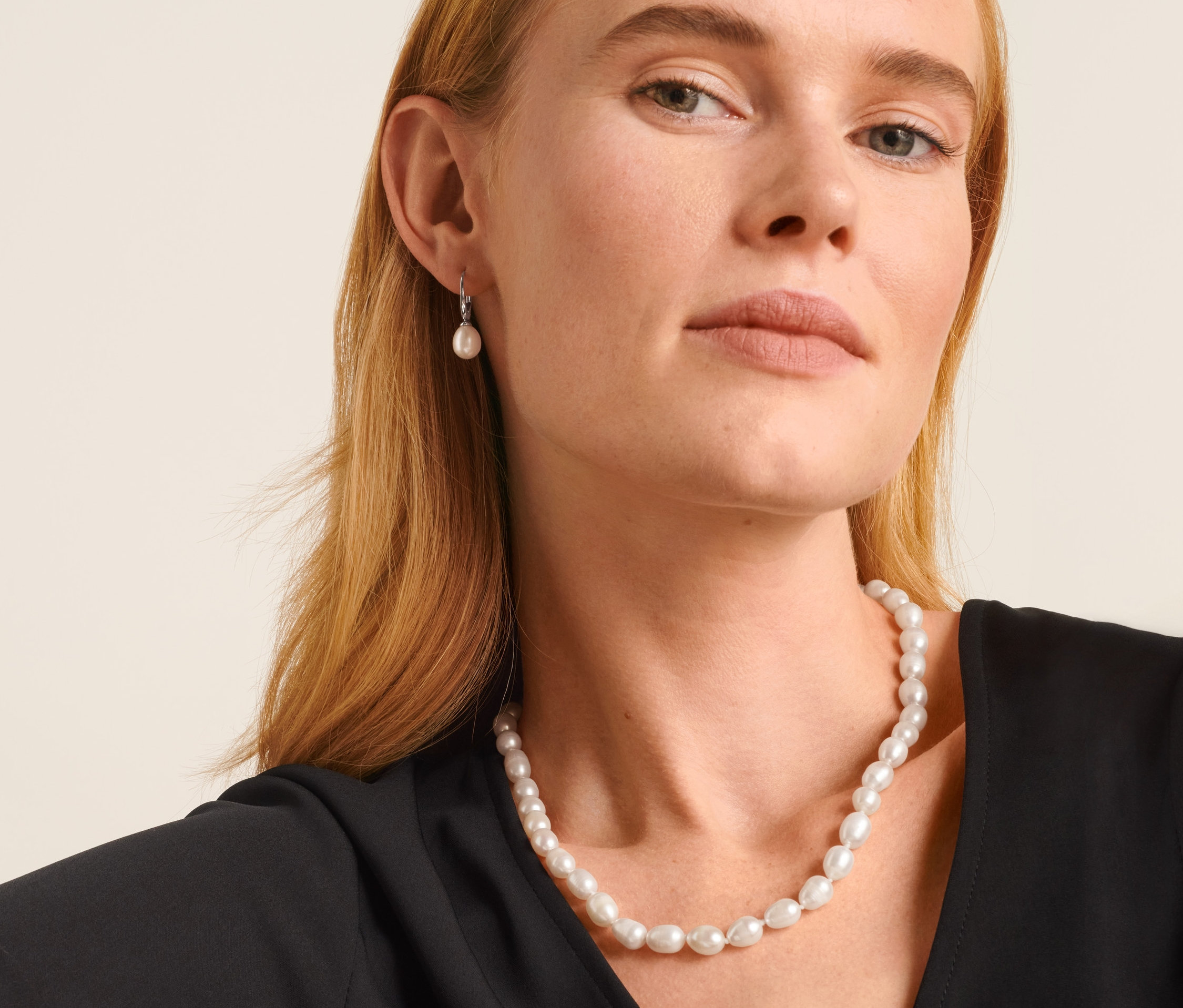 Frau trägt eine 925 Silber Kette mit barocken Süßwasserzuchtperlen und 925 Silber Ohrringe mit Süßwasserzuchtperlen.