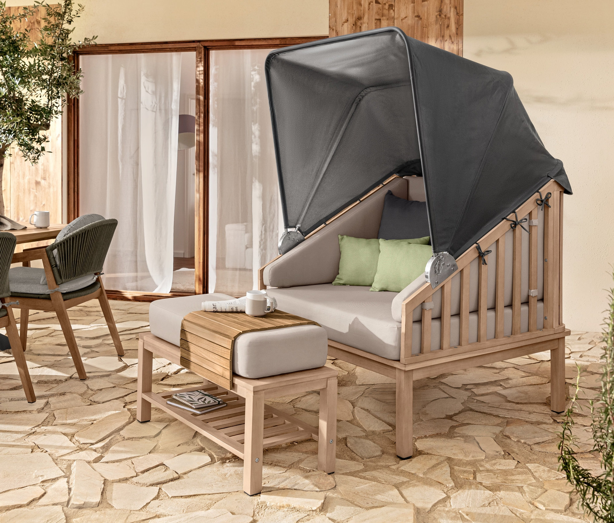 Einrichtung im Freien mit Premium-Lounge-Strandkorb mit Sonnenschutzdach, flexiblem Teak-Sofatablett und 2 Outdoor-Kissen.