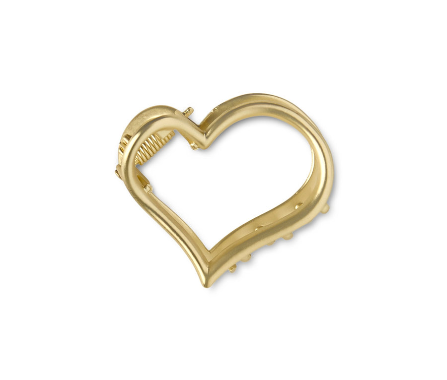 Goldene Haarklemme im Herzdesign auf weißem Hintergrund.