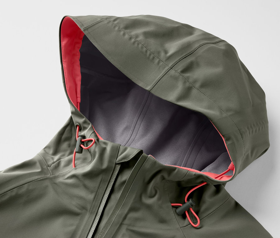 Detailaufnahme einer grünen 3-Lagen-Outdoorjacke mit Kapuze, orangefarbenem Futter und Kordelzug.