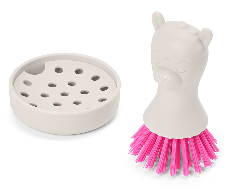 Ein beiger Abtropfbehälter steht neben einer beigen Bürste mit einem Lama-Griff und pinken Borsten.