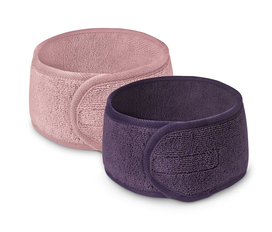 Zwei Kosmetik-Stirnbänder in Rosa und Lila.