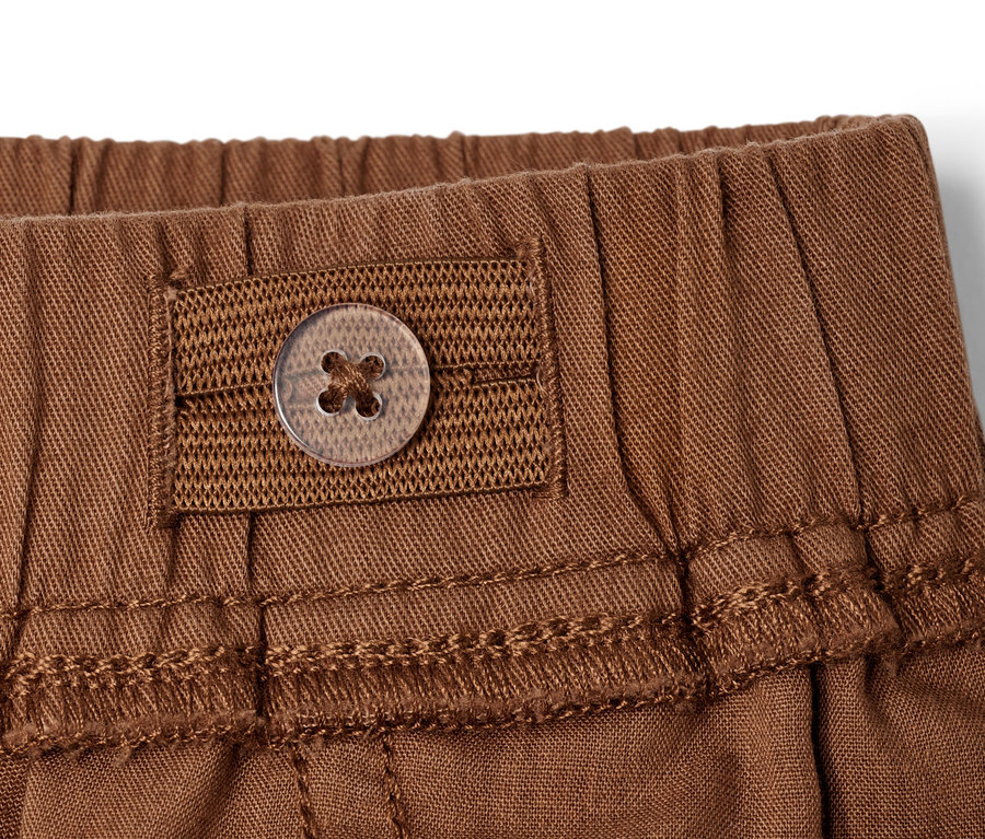 Detailansicht einer braunen Kinder-Pull-on-Hose – Fit »Ella« mit Knopf.