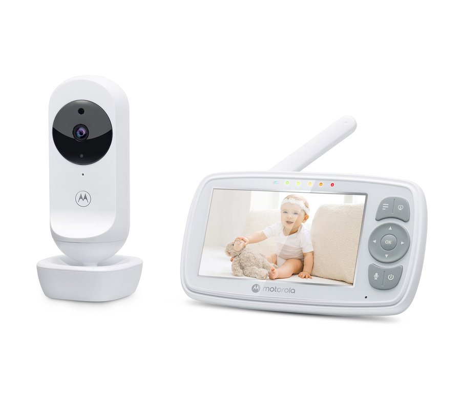 Weißes Video-Babyphone "VM34" mit der Aufnahme eines Babys, das mit einem Teddybär spielt.