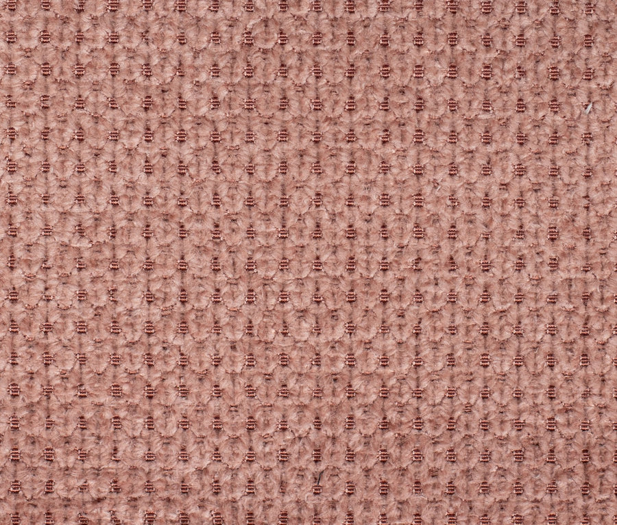 Nahaufnahme des roséfarbenen »Matera« Diningsessels von deVries mit gewebter Textur.