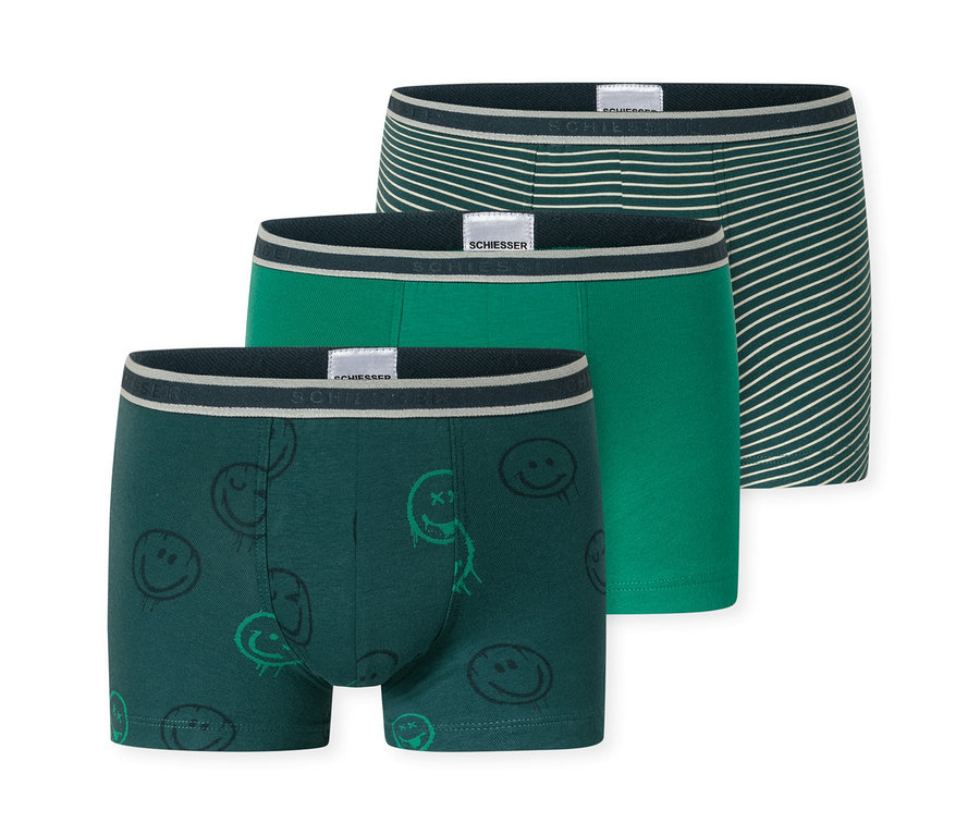 Drei SCHIESSER Kinder-Shorts: eine dunkelgrüne mit Smileys, eine mittelgrüne und eine dunkelgrüne mit weißen Streifen. Alle haben einen SCHIESSER Bund.