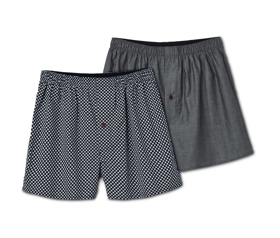 Zwei Web-Boxershorts, eine bedruckt, eine grau.