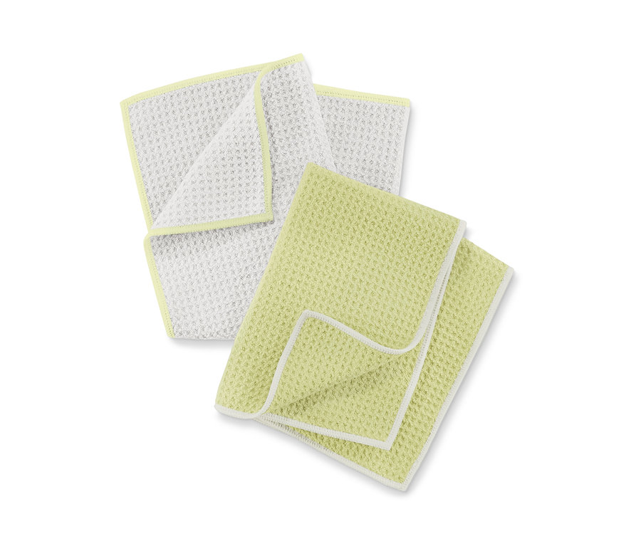 Zwei Trockentücher: eins weiß mit hellgelbem Rand, eins hellgelb mit weißem Rand.