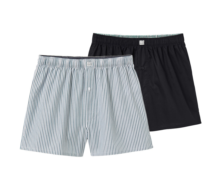 Zwei Web-Boxershorts: eine blau-weiss gestreift, eine schwarz.