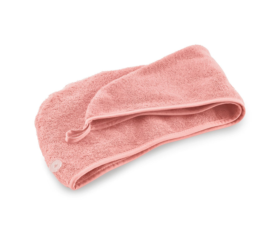 Rosafarbenes Turban-Handtuch auf weißem Hintergrund.