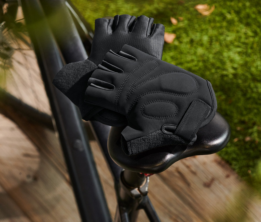 Schwarze Fahrrad-Handschuhe liegen auf einem Fahrradsattel.