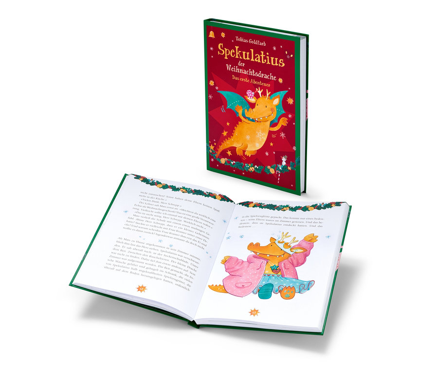 Das Buch "Spekulatius, der Weihnachtsdrache" ist geöffnet und zeigt eine Illustration eines Drachen im rosa Bademantel.