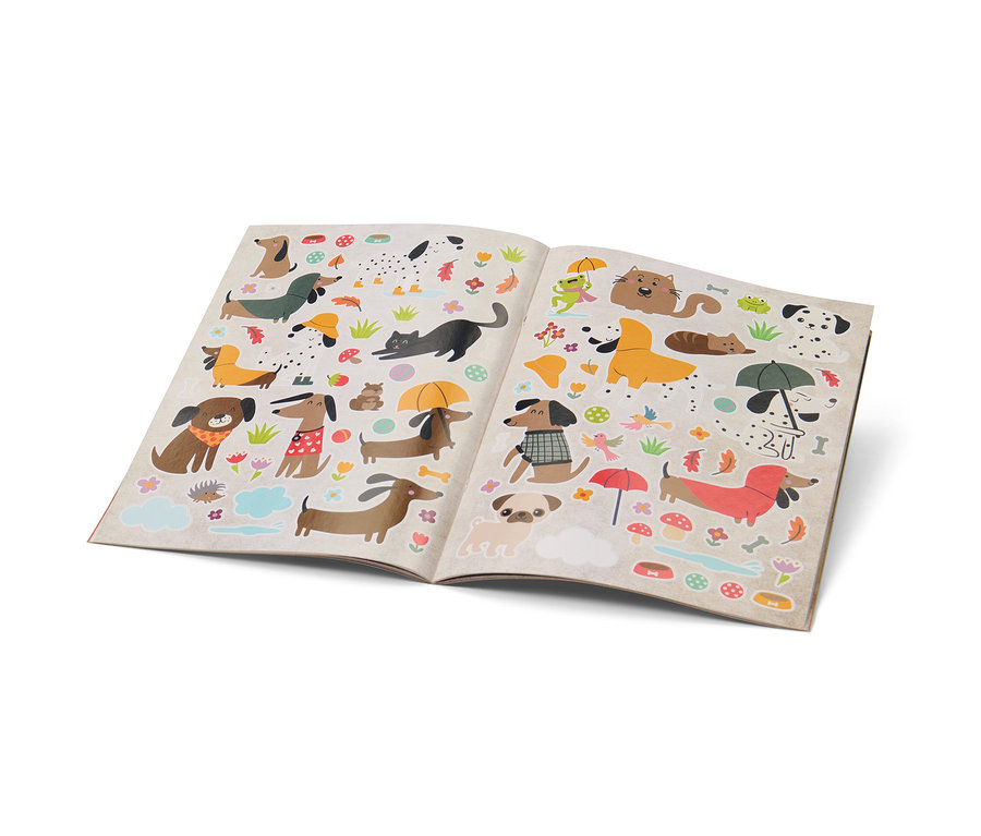 Geöffnetes Buch "Mein Stickerbuch für Regentage" mit Aufklebern von Hunden, Katzen, Pilzen und Regenschirmen.