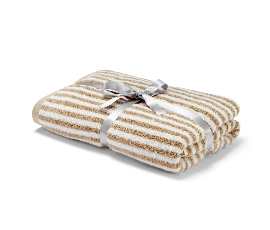 Gefaltetes Premium-Badetuch, naturweiß und beige, mit dekorativem Band.
