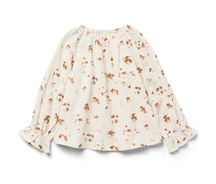 Eine Kinder-Musselin-Bluse mit langen Ärmeln und braunem Blumendruck.