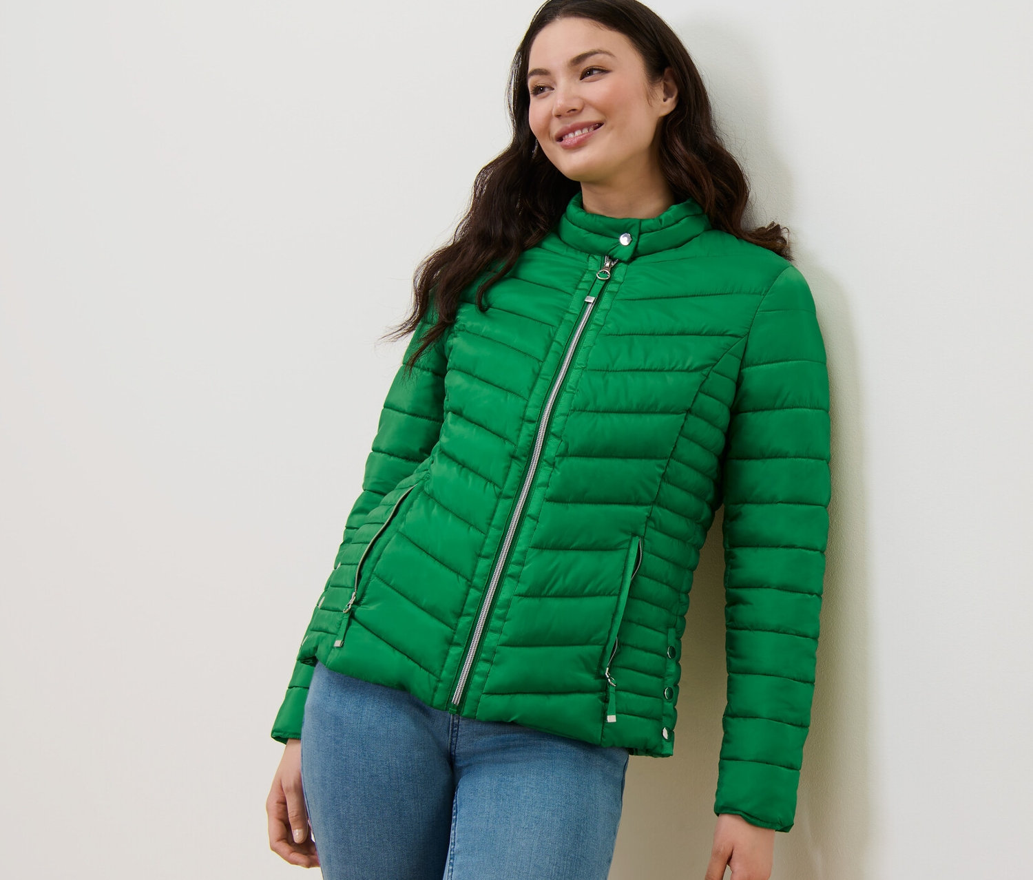 Frau posiert in grüner Steppjacke.