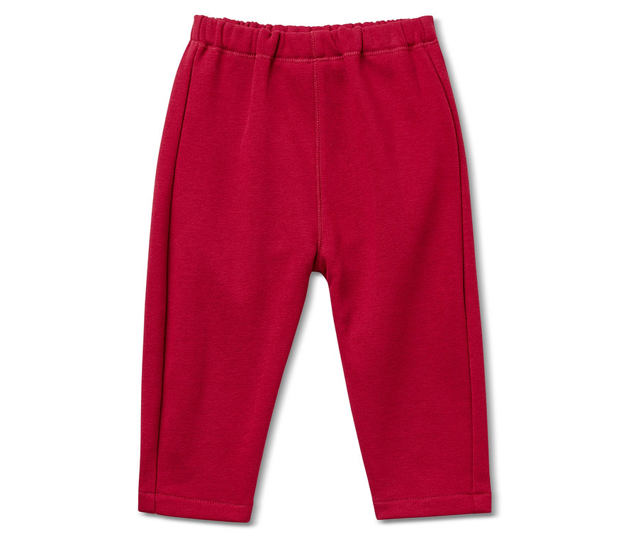 Eine rote Jogginghose mit Gummibund liegt auf einem weißen Hintergrund.