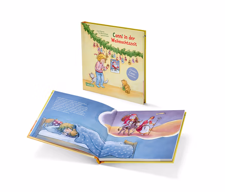 Ein offenes Buch zeigt ein Mädchen, das im Bett schläft und von Nikolaus und Santa träumt.