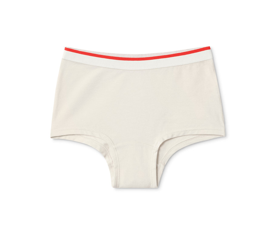 Ein einzelner beiger Mädchen-Pantys mit hellen Bund mit rotem Streifen. 7 Mädchen-Pantys, blau