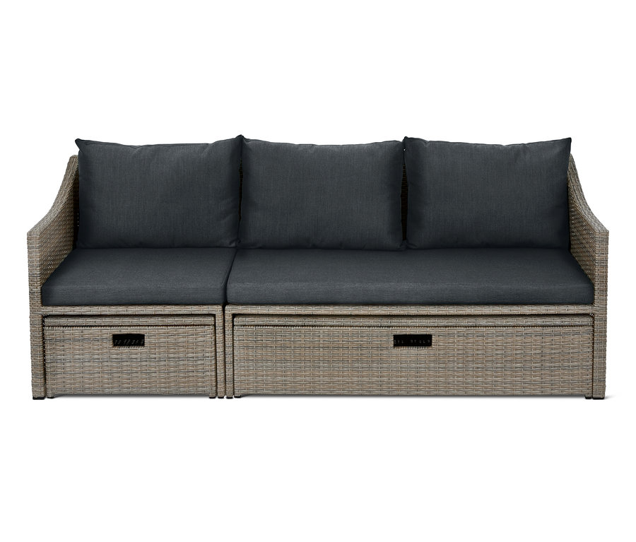 Graues Lounge-Schlafsofa »Thore« mit Ausziehfunktion und dunkelgrauen Kissen.