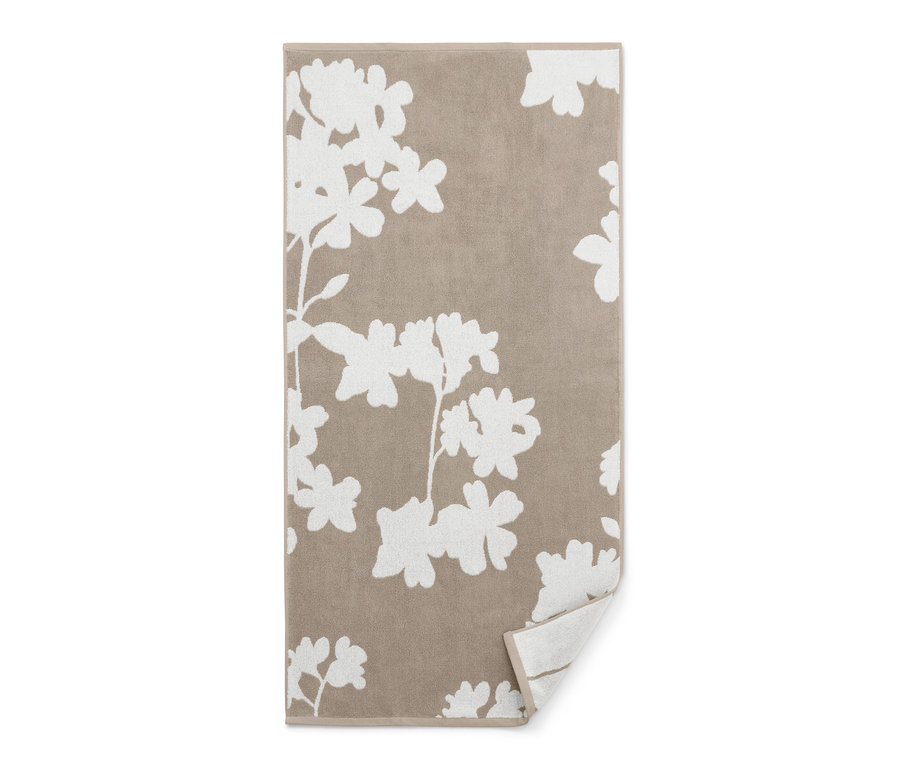 Beiges Jacquard-Badetuch mit Blumenmuster.