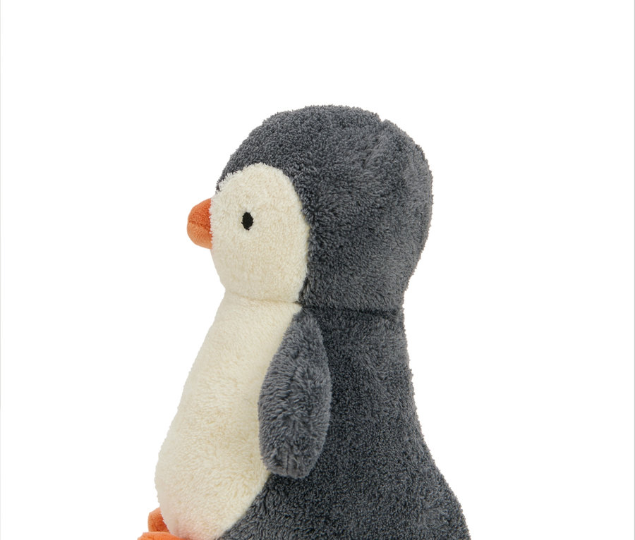 Seitenansicht eines Plüschpinguins mit grauem Rücken und weißem Bauch. Plüschtier »Pinguin«