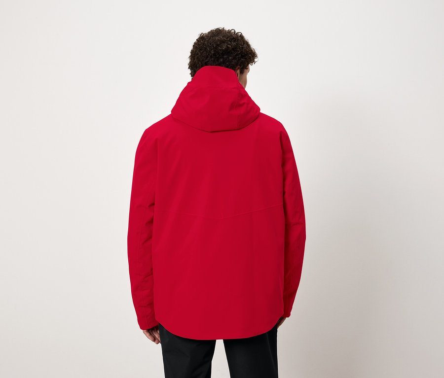 Mann von hinten trägt eine rote Jacke mit Kapuze.