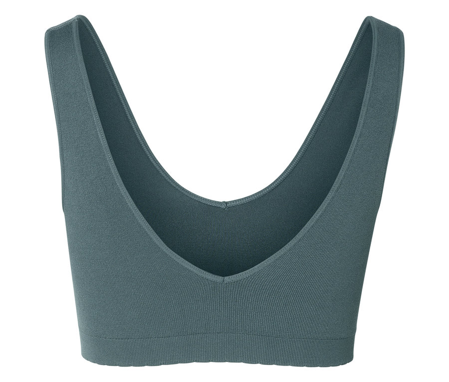 Nahaufnahme eines graublauen Sport-BHs mit V-Ausschnitt auf weißem Hintergrund.