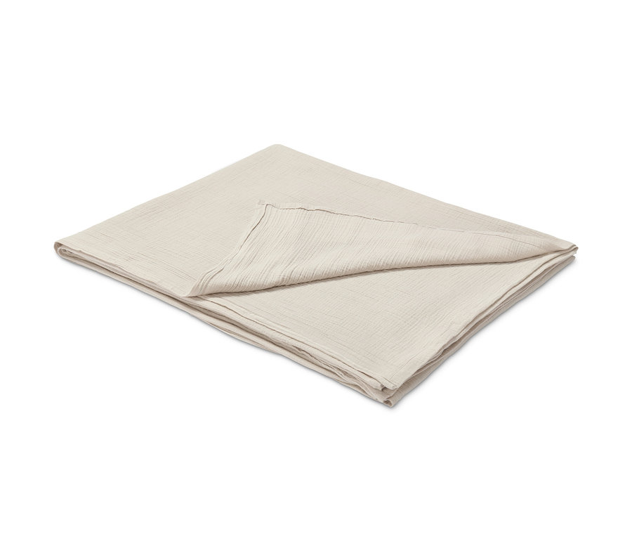 Gefaltete, hellbeige Musselindecke. Vestio-Musselin-Überwurf, hellbeige