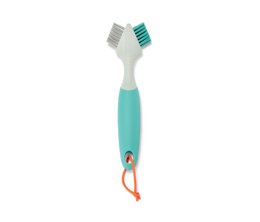 Eine Fugenbürste, soft/hart, mit einem blaugrünen Griff und einer orangefarbenen Schnur.