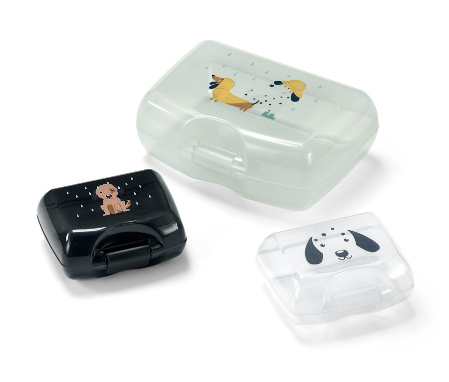 Drei Brotdosen mit Hundeaufdruck.