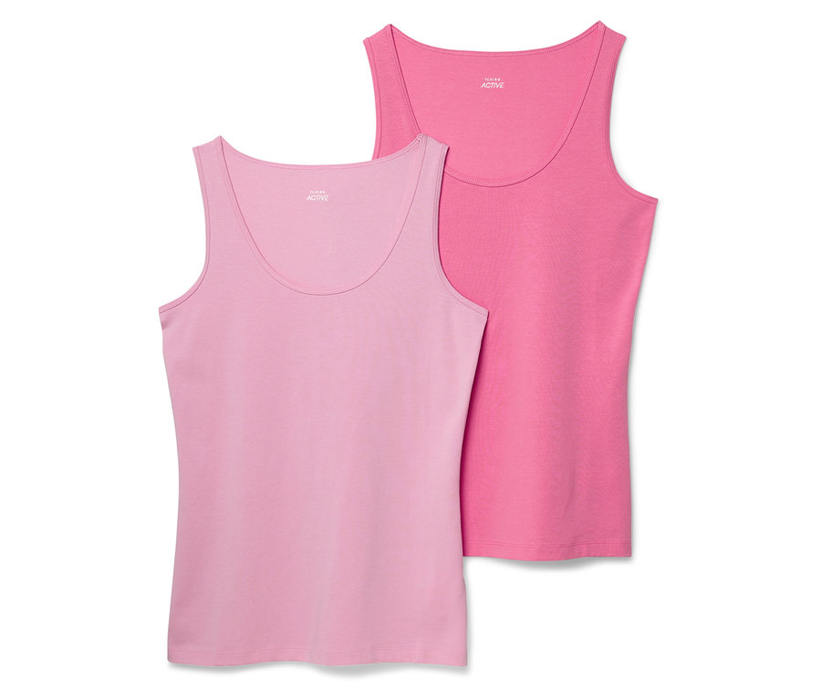 Zwei Damen Tanktops, eines hellrosa und eines rosa, liegen nebeneinander.