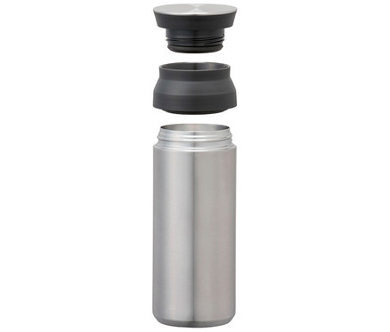 Edelstahlflasche mit abgenommenem Deckel und Zwischenstück, schwebend über der Flasche.